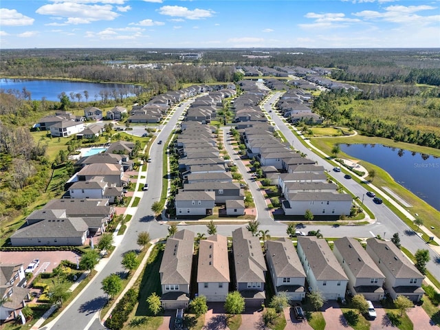 bird's eye view with a residential view and a water view