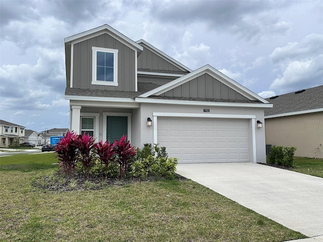 view of front of house featuring a front yard, roof with shingles, an attached garage, concrete driveway, and board and batten siding
