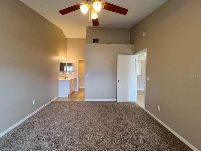 unfurnished bedroom featuring visible vents, baseboards, ceiling fan, light colored carpet, and high vaulted ceiling