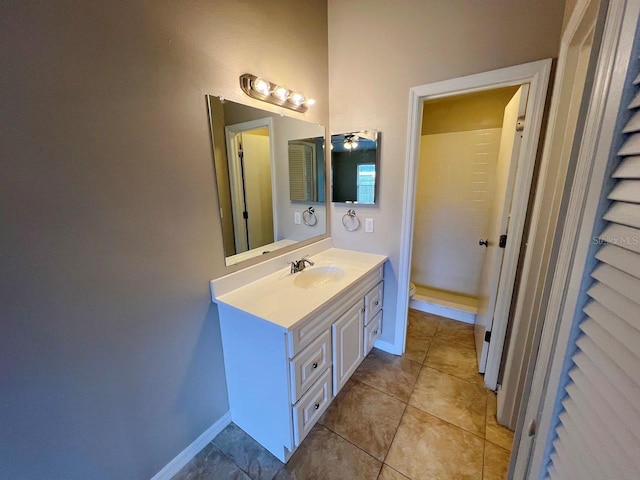 bathroom featuring tile patterned floors, toilet, vanity, and baseboards