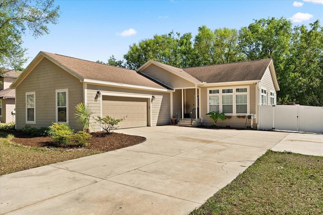 ranch-style house featuring a garage, fence, driveway, and a gate