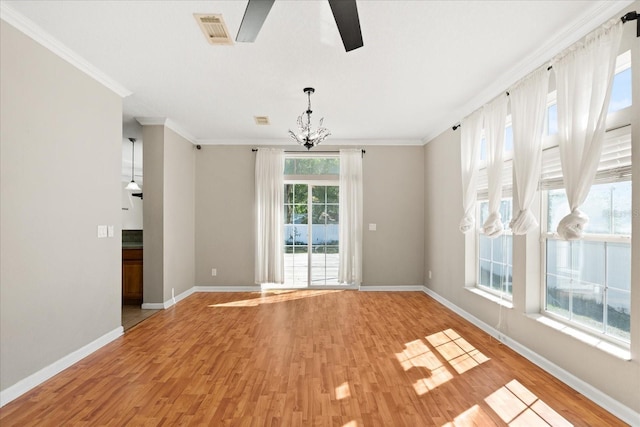 unfurnished dining area featuring light wood-style floors, visible vents, baseboards, and ornamental molding