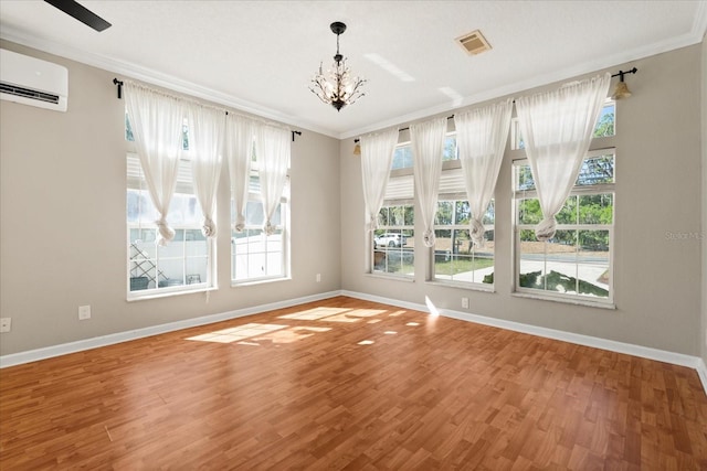 unfurnished room with ornamental molding, visible vents, and wood finished floors