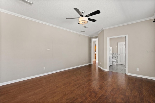 spare room with ornamental molding, ceiling fan, wood finished floors, and a textured ceiling