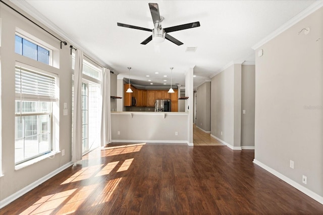 unfurnished living room featuring crown molding, wood finished floors, ceiling fan, and visible vents