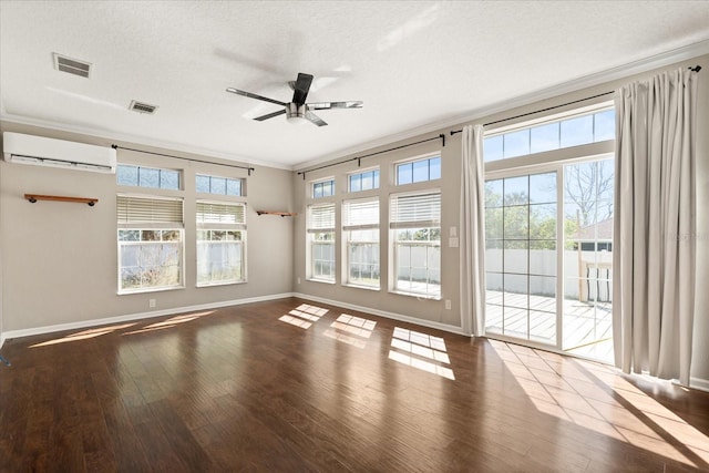 unfurnished room with ornamental molding, visible vents, a ceiling fan, and a wall mounted AC