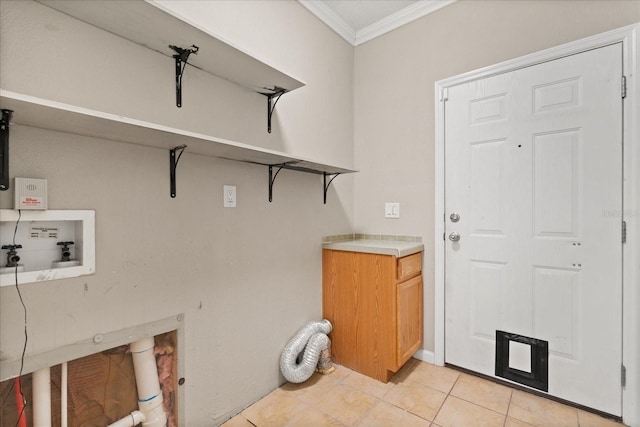 clothes washing area with light tile patterned floors, laundry area, ornamental molding, and washer hookup