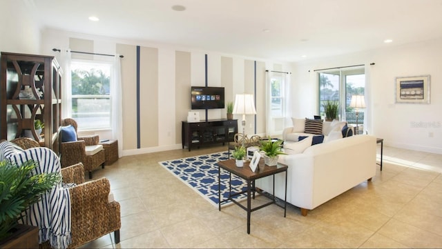living area featuring recessed lighting, baseboards, and light tile patterned floors