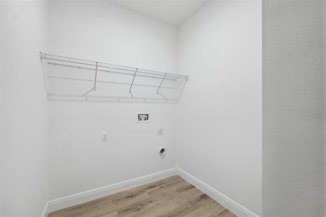 7564 N Gims Way, Citrus Springs, FL 34433 - laundry area with hookup for an electric dryer, hookup for a washing machine, light wood finished floors, and baseboards