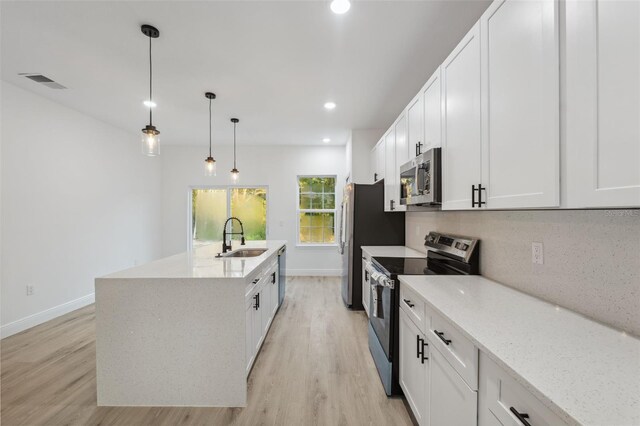 7564 N Gims Way, Citrus Springs, FL 34433 - kitchen featuring appliances with stainless steel finishes, a sink, baseboards, light wood finished floors, and white cabinetry
