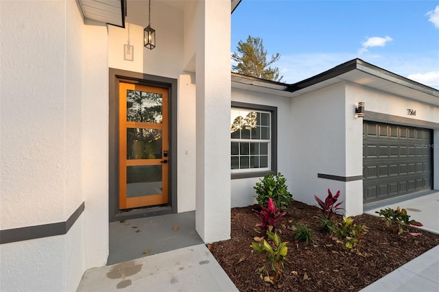 7564 N Gims Way, Citrus Springs, FL 34433 - doorway to property with stucco siding, a garage, and concrete driveway