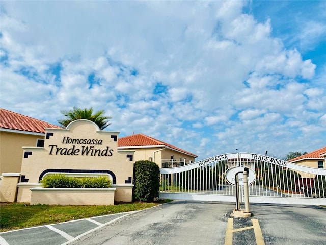 4865 S Tromp Loop Unit 136, Homosassa, FL 34448 - view of asphalt street with a gate and a gated entry