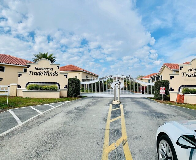 4865 S Tromp Loop Unit 136, Homosassa, FL 34448 - view of asphalt road with a gate and a gated entry