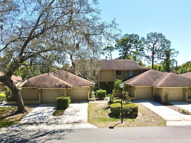 1886 Saint Andrews Pl Unit 1886, Longwood, FL 32779 - view of front facade with concrete driveway, an attached garage, and stucco siding