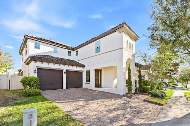 14645 Scott Key Dr, Winter Garden, FL 34787 - mediterranean / spanish home featuring stucco siding, a tiled roof, driveway, and a gate