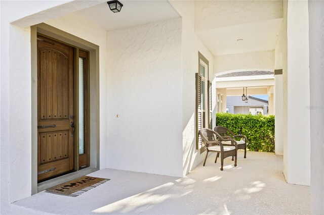 14645 Scott Key Dr, Winter Garden, FL 34787 - view of exterior entry with stucco siding and covered porch