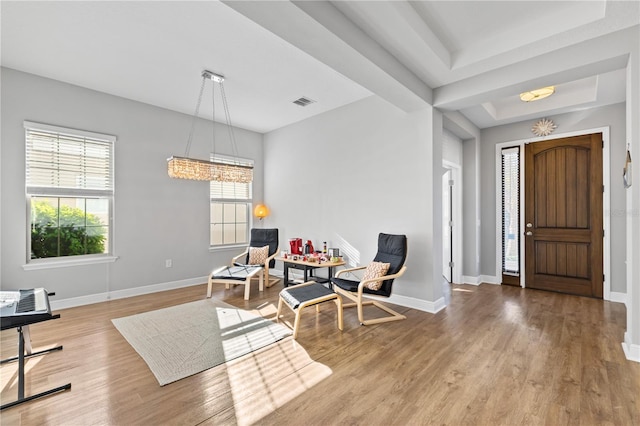 14645 Scott Key Dr, Winter Garden, FL 34787 - entryway featuring a notable chandelier, a tray ceiling, baseboards, and wood finished floors