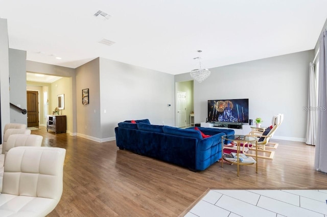 14645 Scott Key Dr, Winter Garden, FL 34787 - living room with a notable chandelier, baseboards, visible vents, and wood finished floors