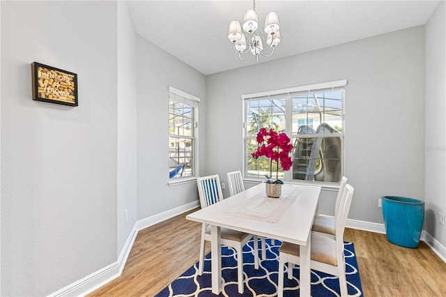 14645 Scott Key Dr, Winter Garden, FL 34787 - dining space featuring an inviting chandelier, wood finished floors, and baseboards