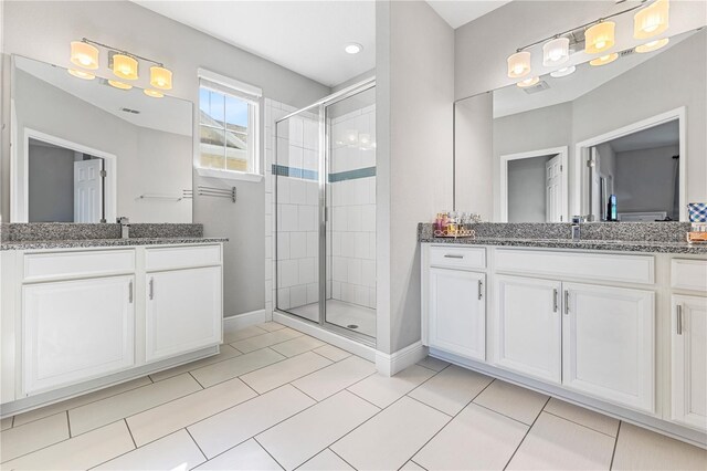 14645 Scott Key Dr, Winter Garden, FL 34787 - bathroom featuring tile patterned flooring, a stall shower, two vanities, and a sink