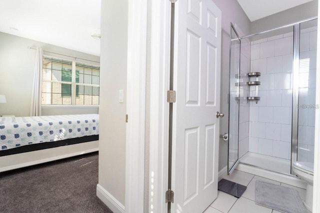 14645 Scott Key Dr, Winter Garden, FL 34787 - ensuite bathroom featuring tile patterned flooring, baseboards, ensuite bathroom, and tiled shower