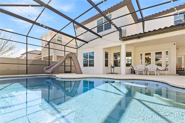 14645 Scott Key Dr, Winter Garden, FL 34787 - view of pool featuring a patio, glass enclosure, french doors, a water slide, and a fenced in pool