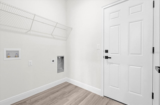 washroom with baseboards, light wood finished floors, hookup for an electric dryer, laundry area, and washer hookup