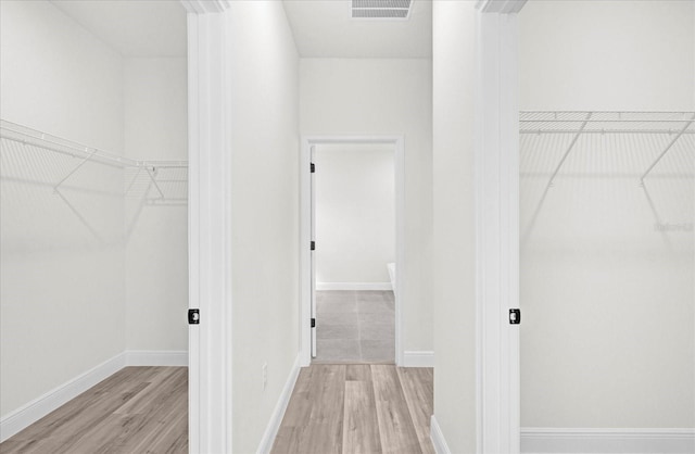 walk in closet featuring wood finished floors and visible vents
