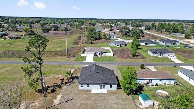 birds eye view of property with a residential view
