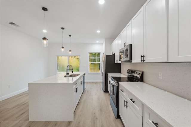 7550 N Gims Way, Citrus Springs, FL 34433 - kitchen featuring appliances with stainless steel finishes, a sink, baseboards, light wood finished floors, and white cabinetry
