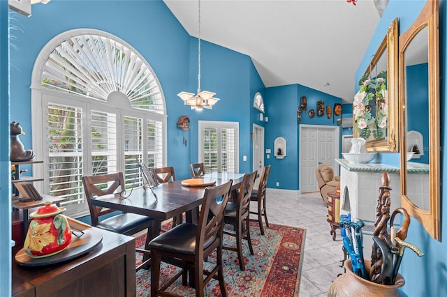 10589 Pelican Dr, Wellington, FL 33414 - dining area with a notable chandelier, light tile patterned floors, baseboards, and high vaulted ceiling
