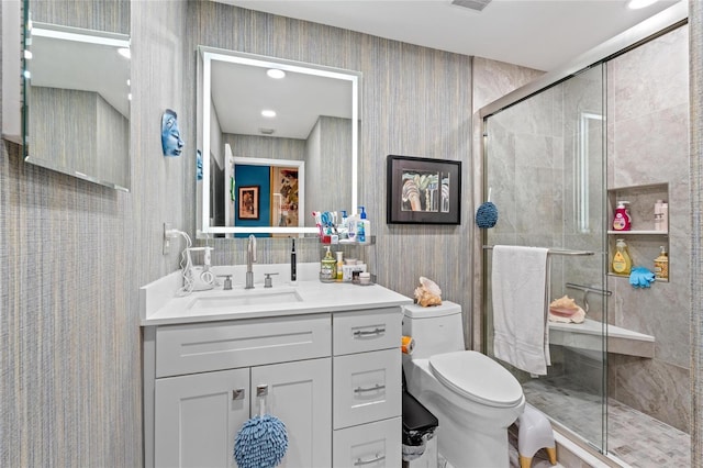 10589 Pelican Dr, Wellington, FL 33414 - full bath featuring vanity, visible vents, wallpapered walls, a stall shower, and toilet