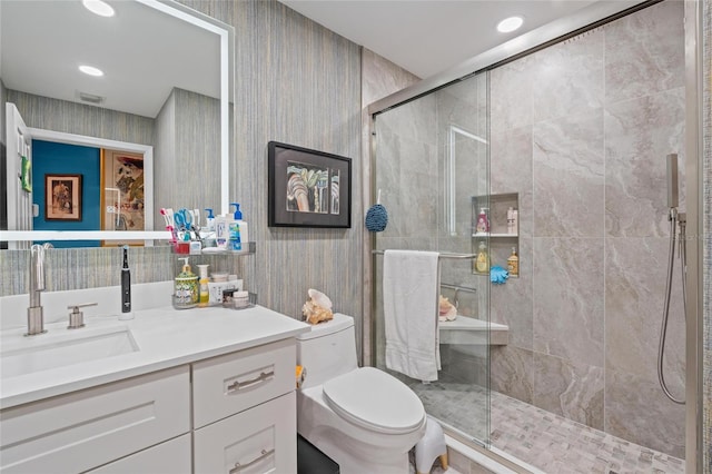 10589 Pelican Dr, Wellington, FL 33414 - bathroom with vanity, visible vents, wallpapered walls, a tile shower, and toilet