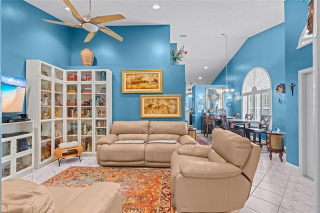 10589 Pelican Dr, Wellington, FL 33414 - living area featuring tile patterned flooring, a textured ceiling, ceiling fan with notable chandelier, and high vaulted ceiling