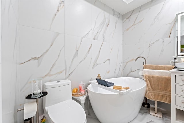 10589 Pelican Dr, Wellington, FL 33414 - bathroom featuring stone wall, a freestanding tub, marble finish floor, and vanity