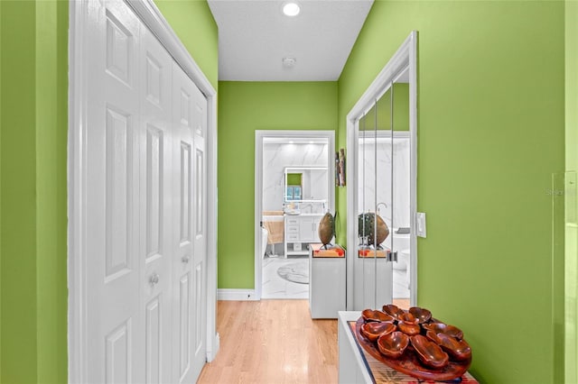 10589 Pelican Dr, Wellington, FL 33414 - hallway with light wood-style flooring and baseboards