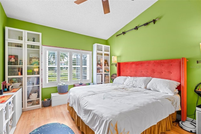 10589 Pelican Dr, Wellington, FL 33414 - bedroom featuring a textured ceiling, wood finished floors, a ceiling fan, and vaulted ceiling