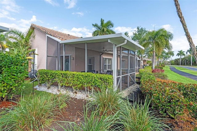 10589 Pelican Dr, Wellington, FL 33414 - view of side of home with a sunroom and stucco siding