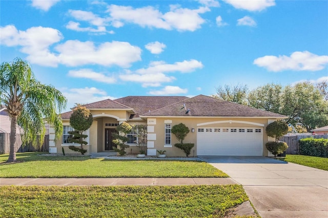 2361 Baker Ave, Orlando, FL 32833 - view of front of house featuring stucco siding, driveway, fence, a front yard, and a garage