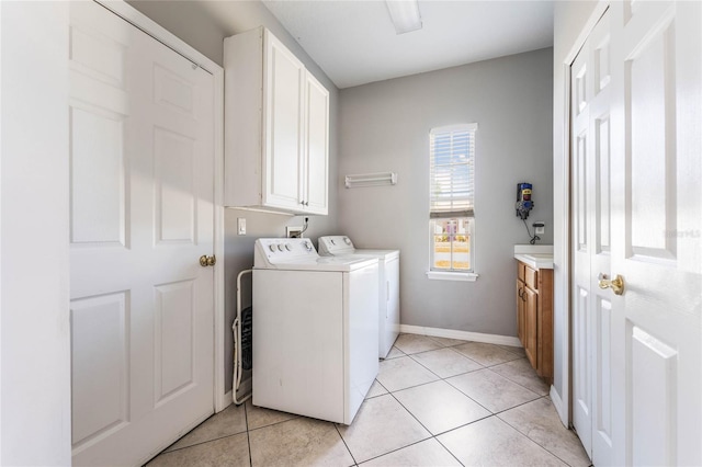2361 Baker Ave, Orlando, FL 32833 - laundry room with washer and clothes dryer, cabinet space, baseboards, and light tile patterned flooring