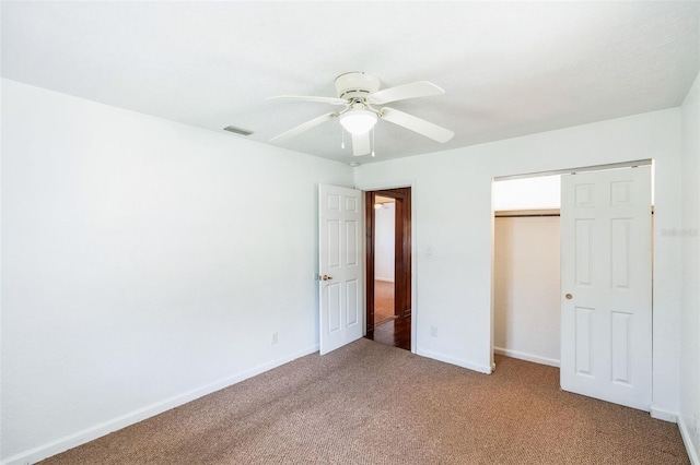 unfurnished bedroom with a ceiling fan, carpet, visible vents, baseboards, and a closet