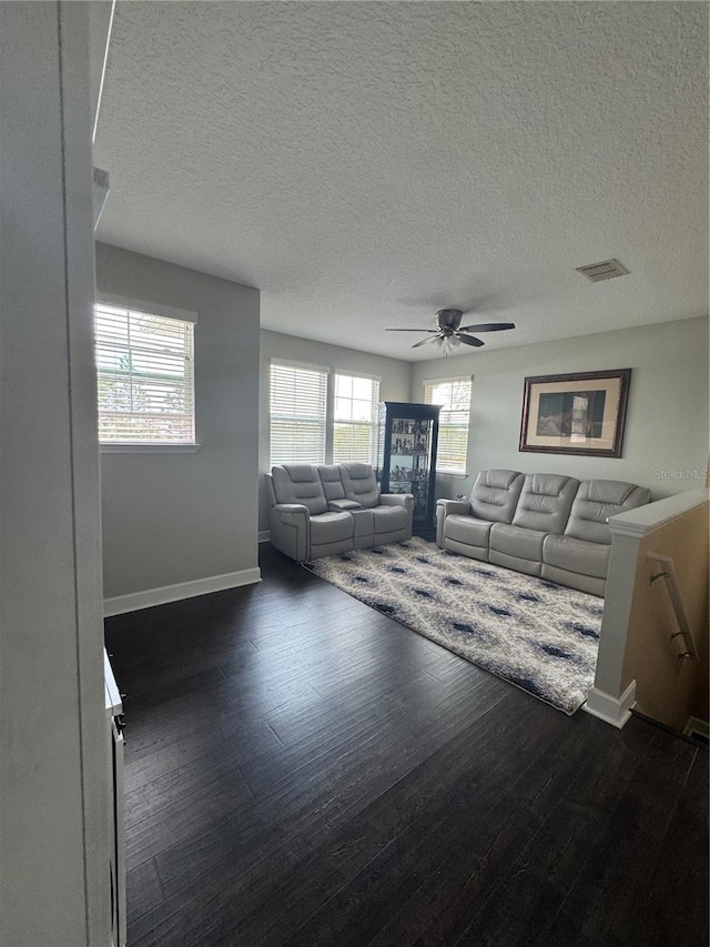 1337 Ash Tree Cv, Casselberry, FL 32707 - unfurnished living room featuring ceiling fan, baseboards, dark wood finished floors, and visible vents