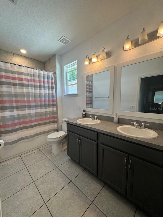 1337 Ash Tree Cv, Casselberry, FL 32707 - full bathroom with tile patterned flooring, a textured ceiling, a sink, and toilet