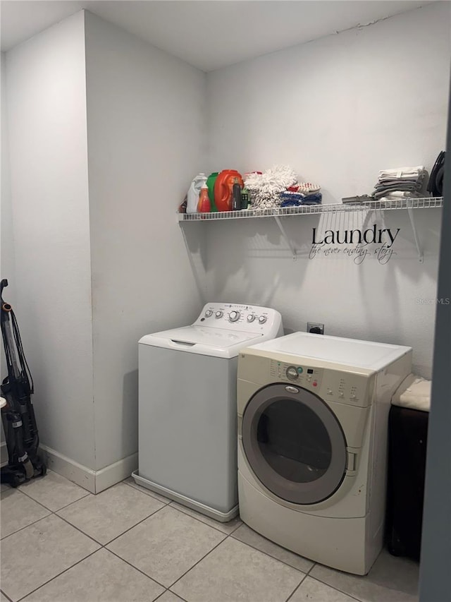 1337 Ash Tree Cv, Casselberry, FL 32707 - laundry area with light tile patterned floors, baseboards, separate washer and dryer, and laundry area