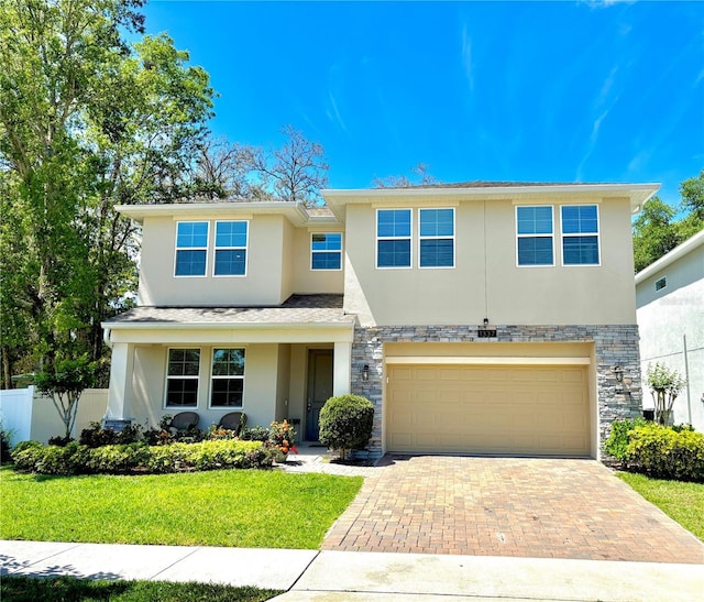 1337 Ash Tree Cv, Casselberry, FL 32707 - view of front facade with stucco siding, decorative driveway, fence, stone siding, and an attached garage