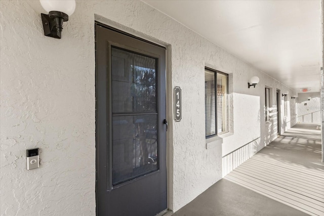 property entrance with stucco siding