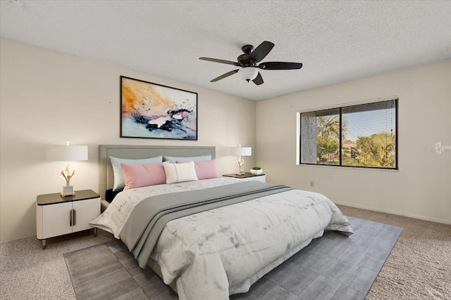 carpeted bedroom featuring a textured ceiling and ceiling fan