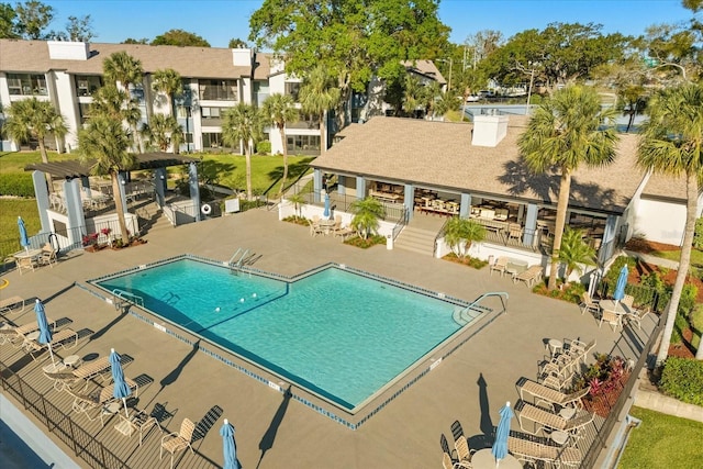 community pool featuring a patio and fence