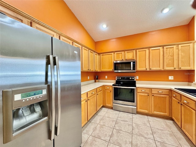 2519 Cypress Trace Cir, Orlando, FL 32825 - kitchen with appliances with stainless steel finishes, a textured ceiling, light countertops, light tile patterned flooring, and a sink
