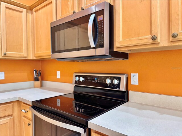 2519 Cypress Trace Cir, Orlando, FL 32825 - kitchen featuring appliances with stainless steel finishes, light brown cabinetry, and light countertops